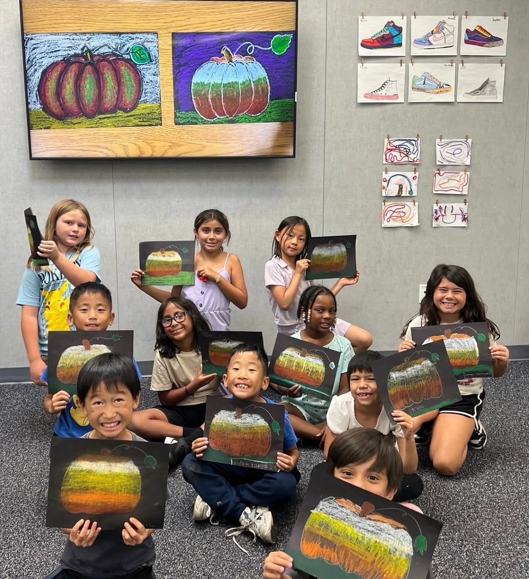 Students showing off their art masterpieces. 