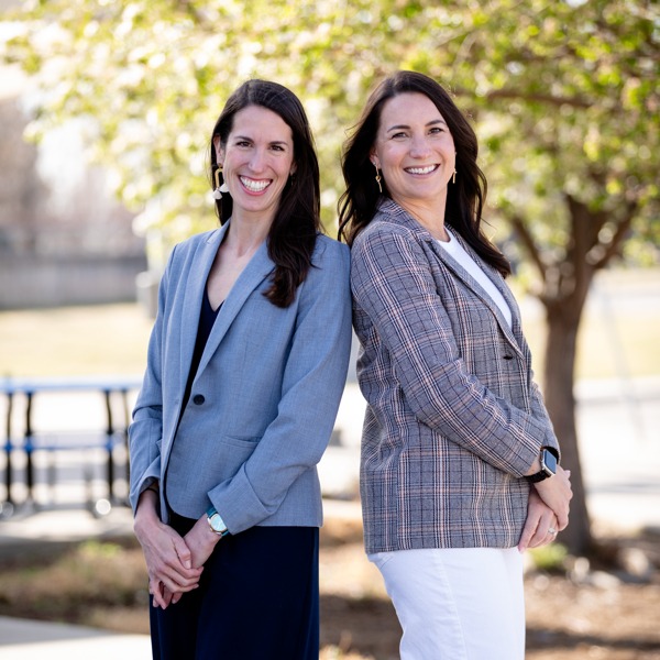 Principa and Assistant Principal standing in front of school