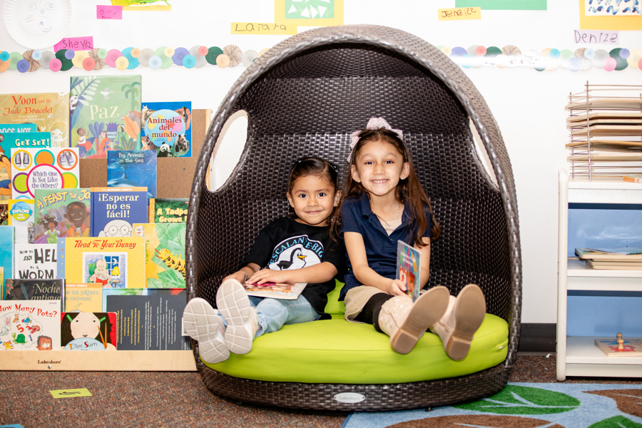 two students sitting in reading nook