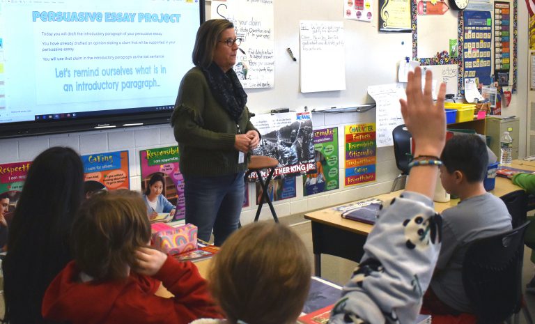 Student raising hand during class