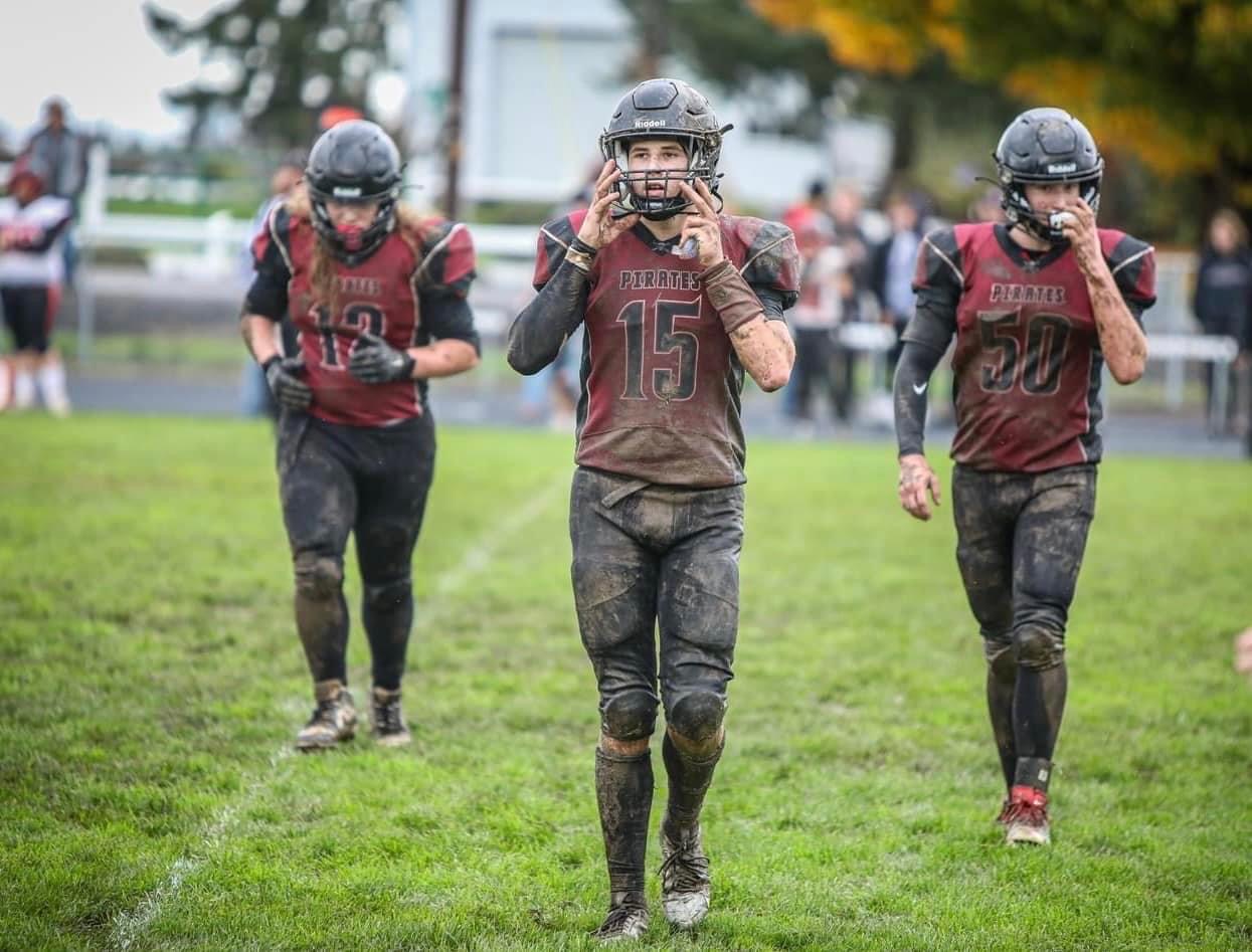football players on muddy field