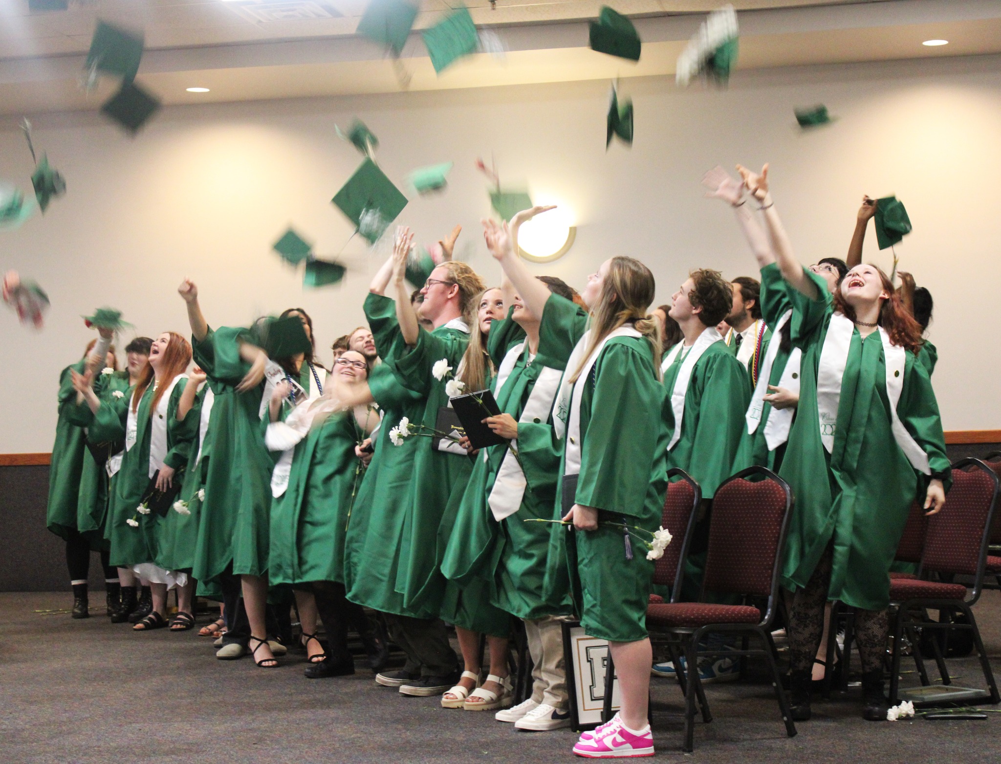 Graduating students throwing graduation caps