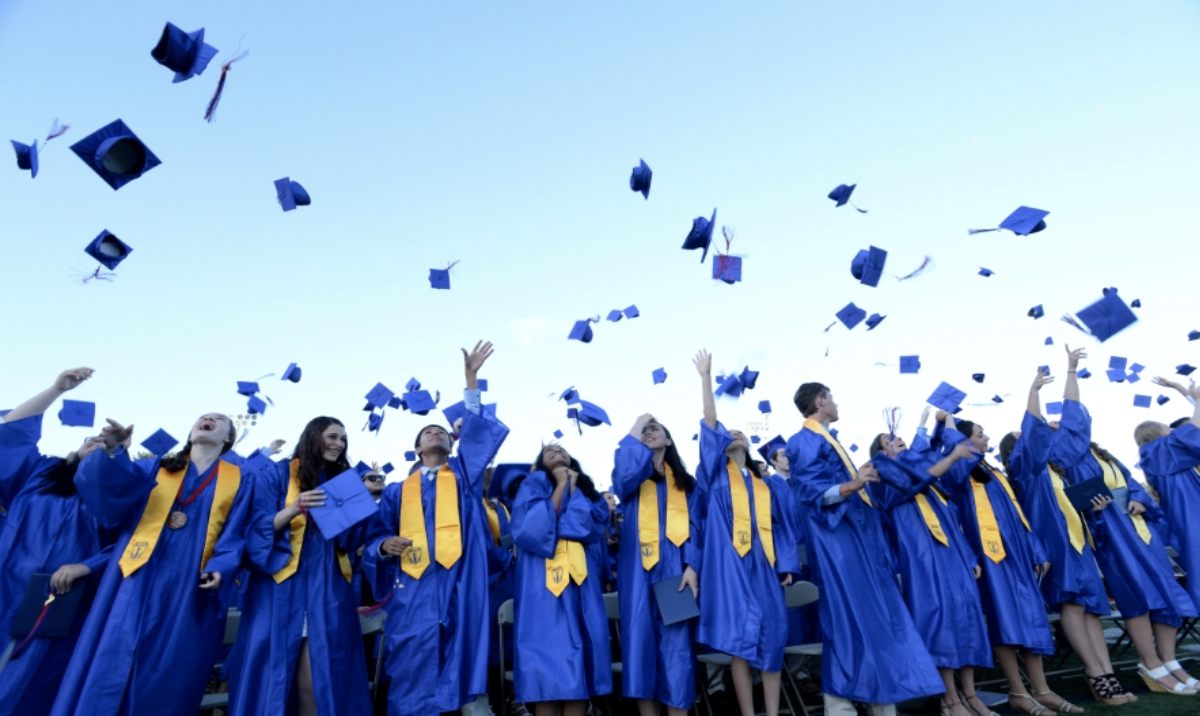 graduated studing throwing graduating cap