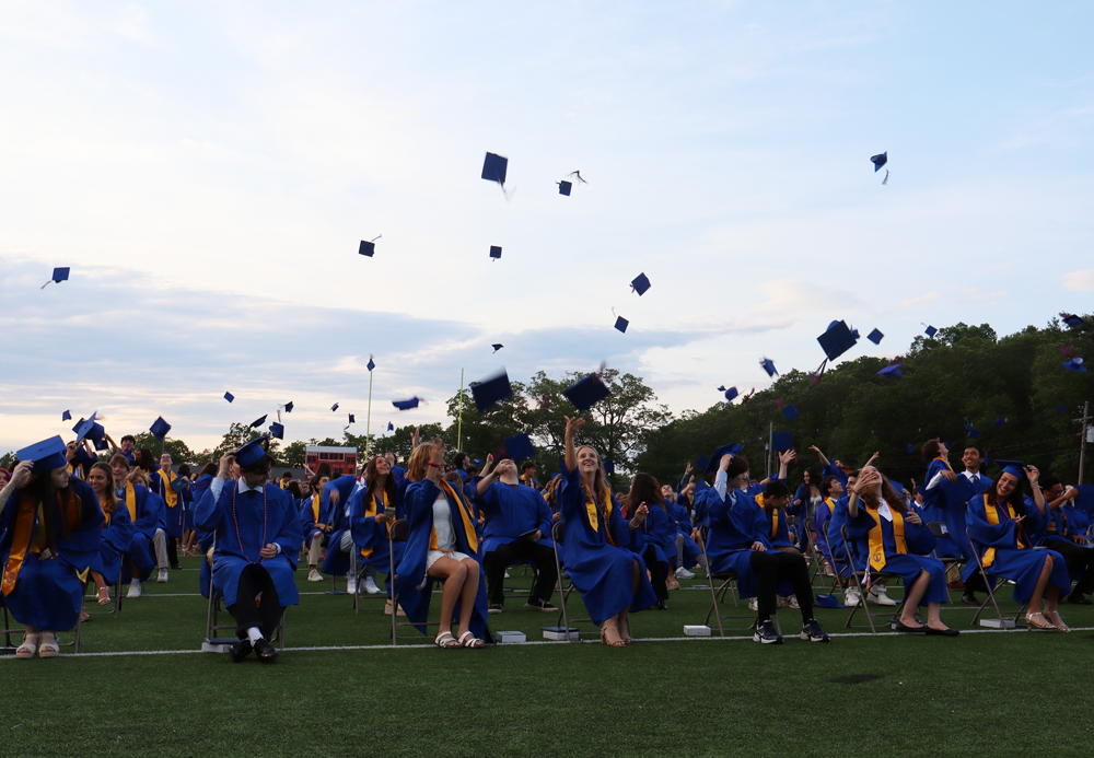 graduation. students throwing caps in the air.