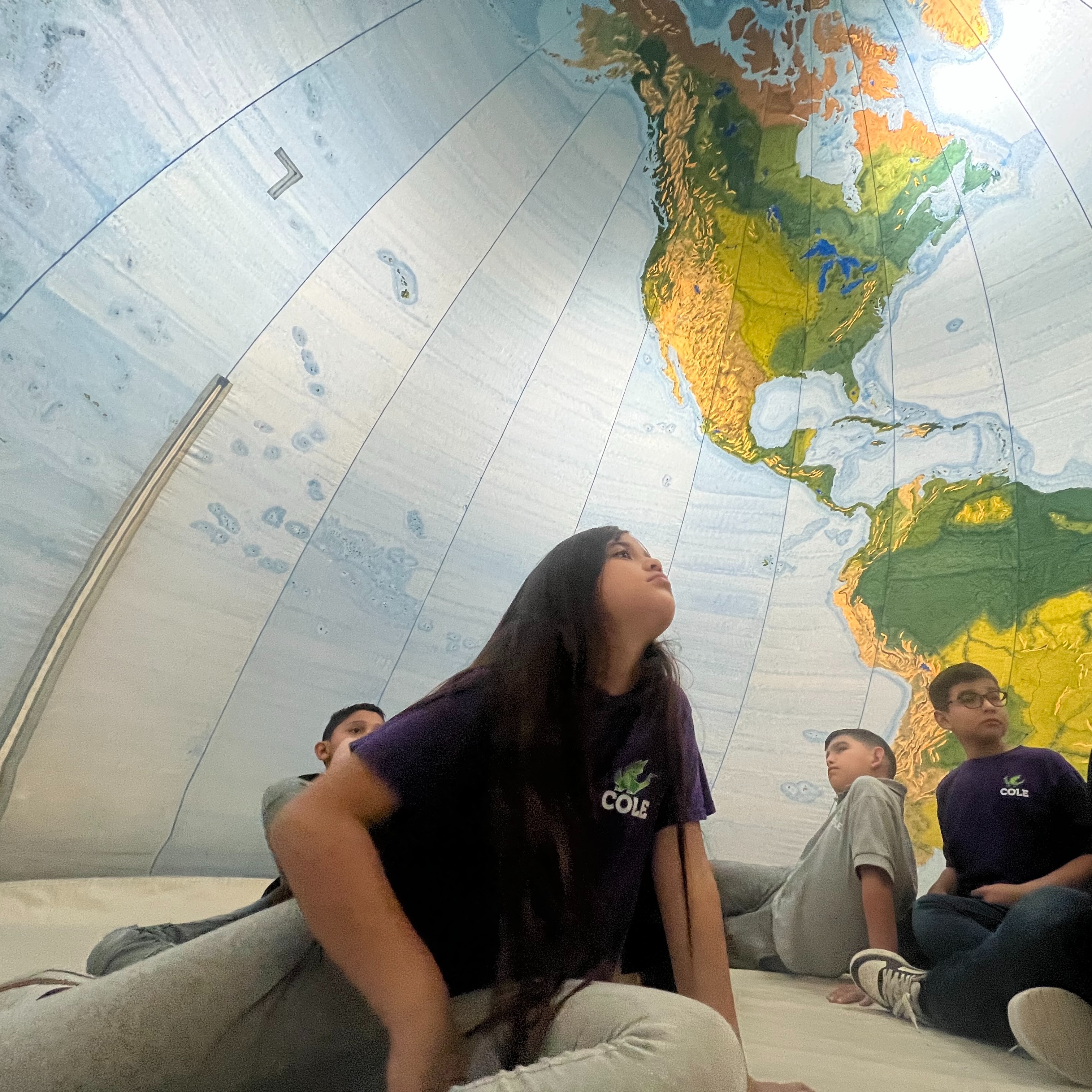student with map behind them