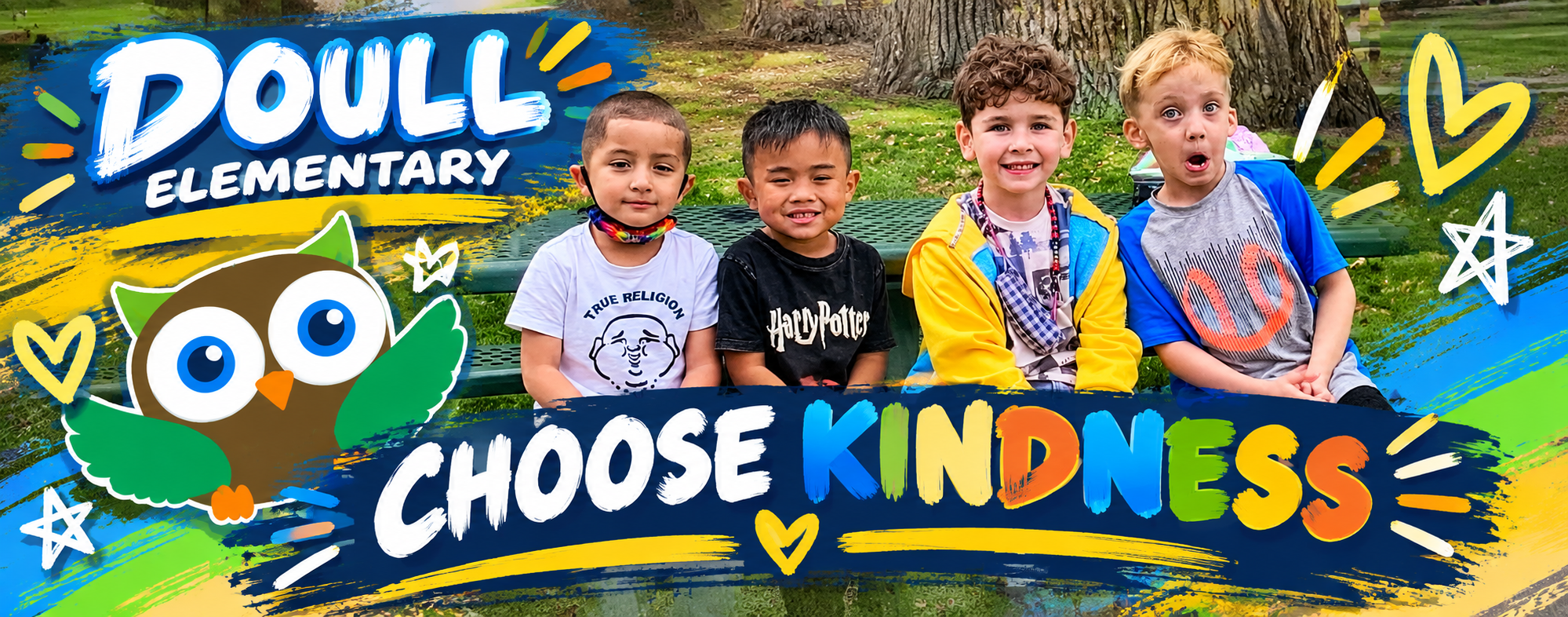 Four boys sit on a bench with a large, colorful "Choose Kindness" banner in front.