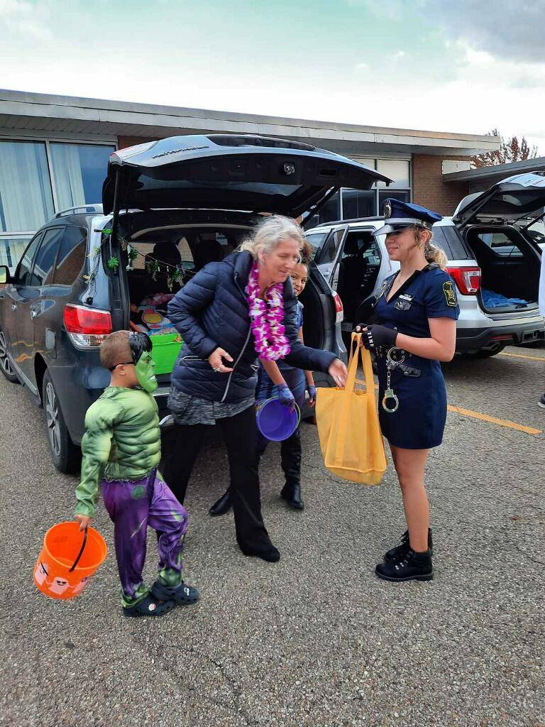 truck or treat a kid in a cop outfit and hulk outfit