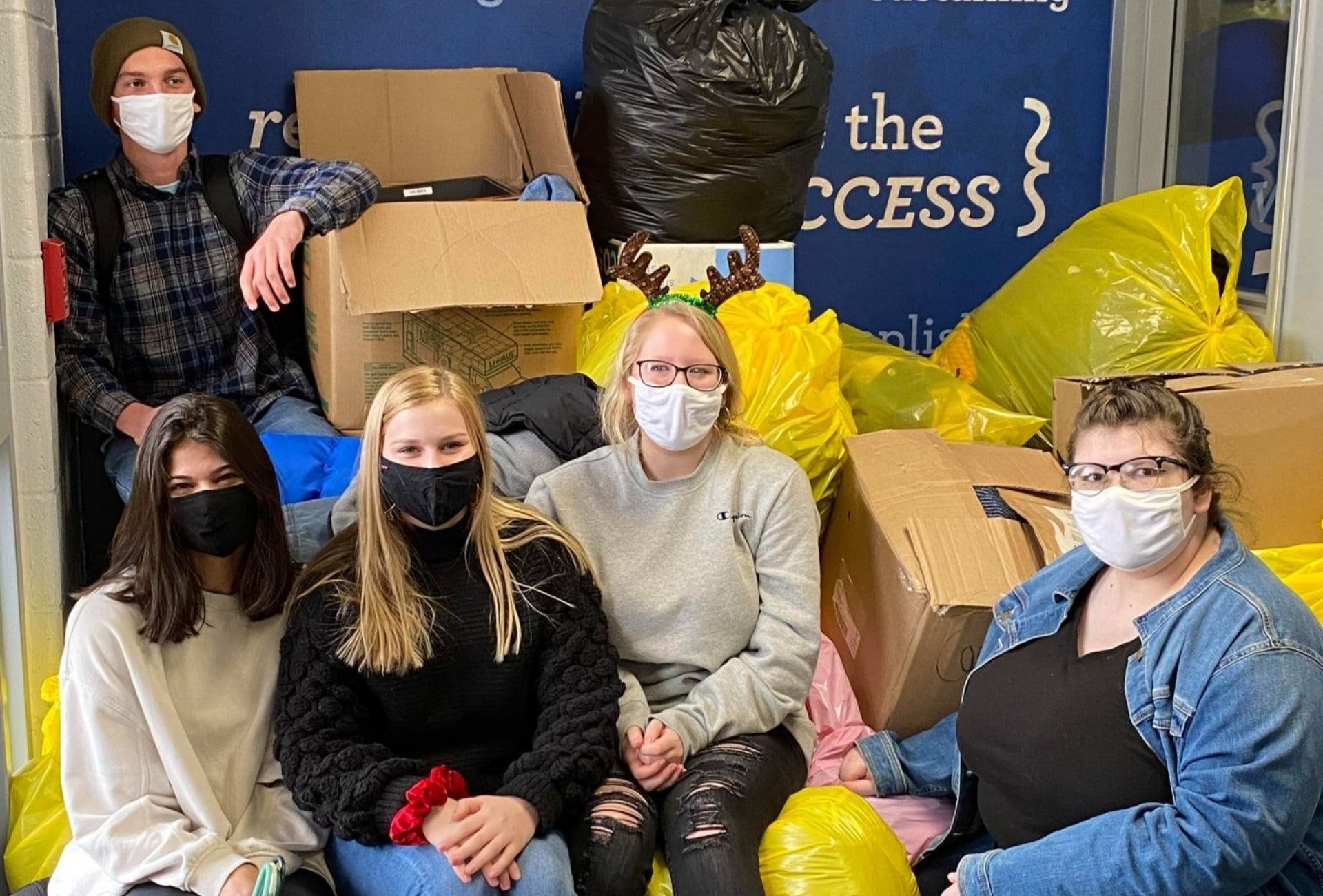 Students and staff posing with masks