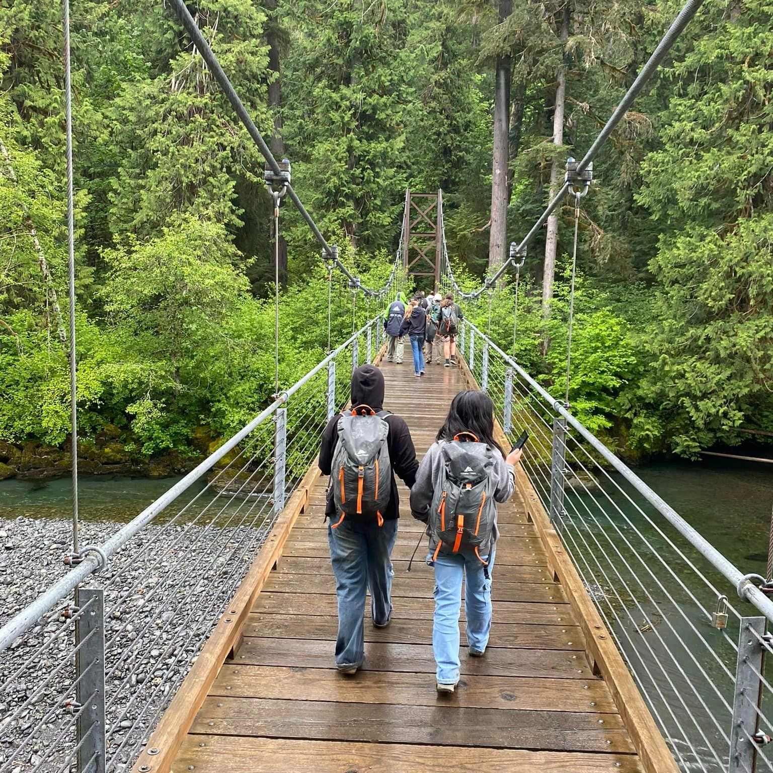 Students Hiking across bridge