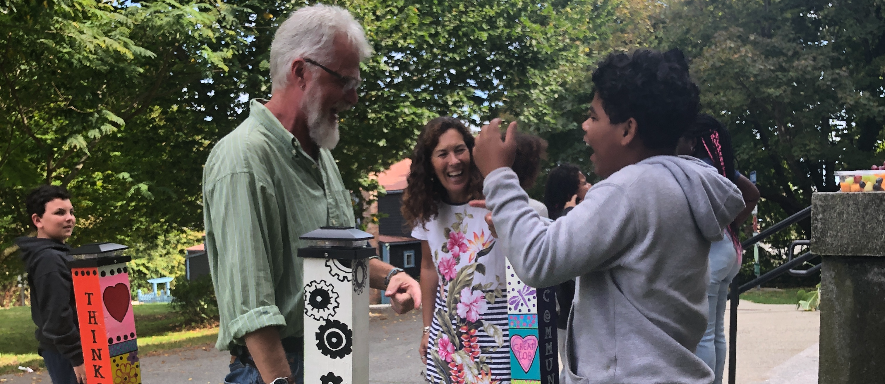 teachers and students plant peace poles outside school