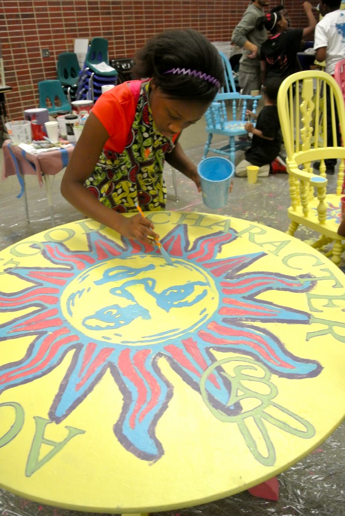 student painting a table