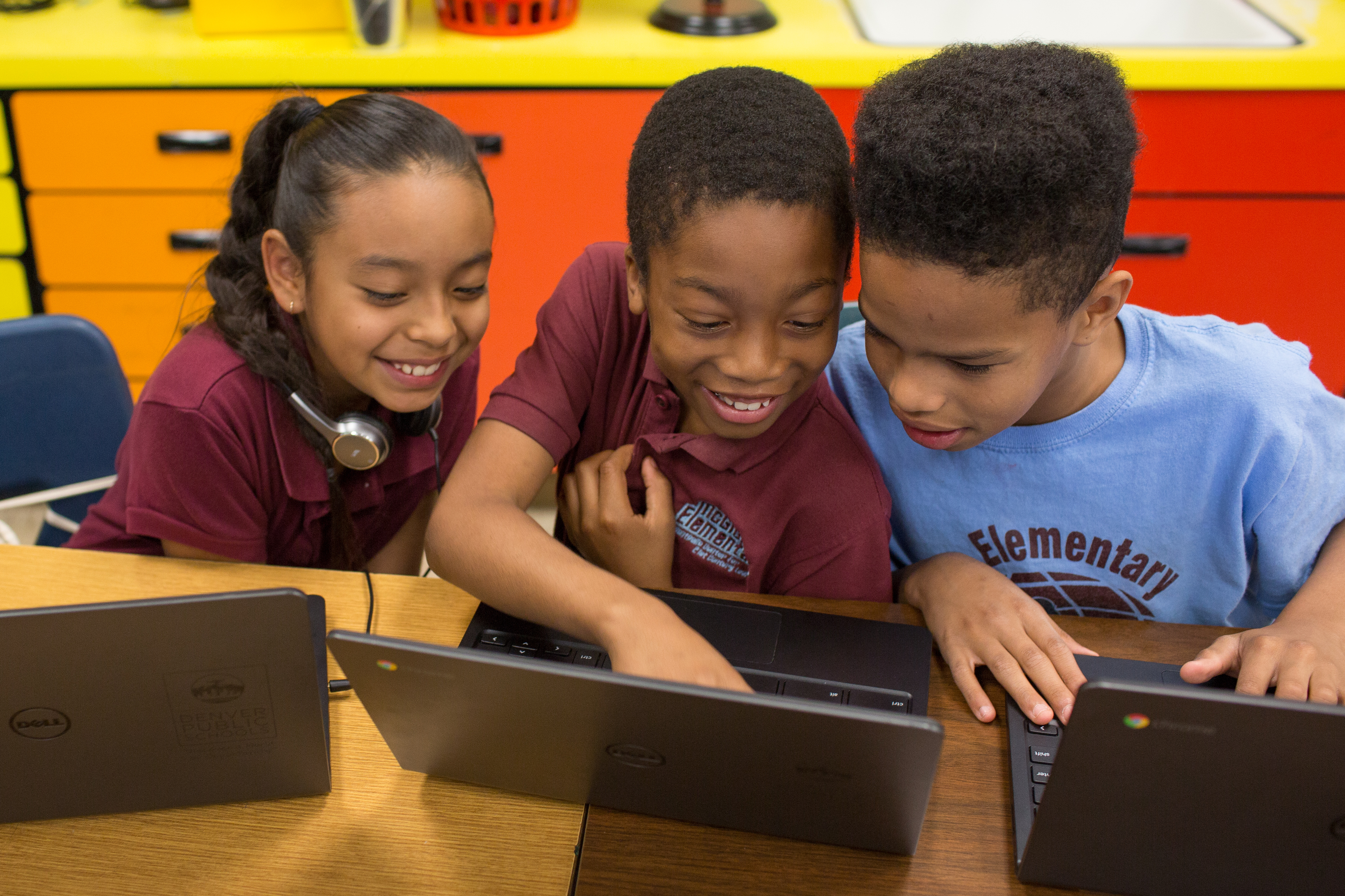 kids looking at laptops