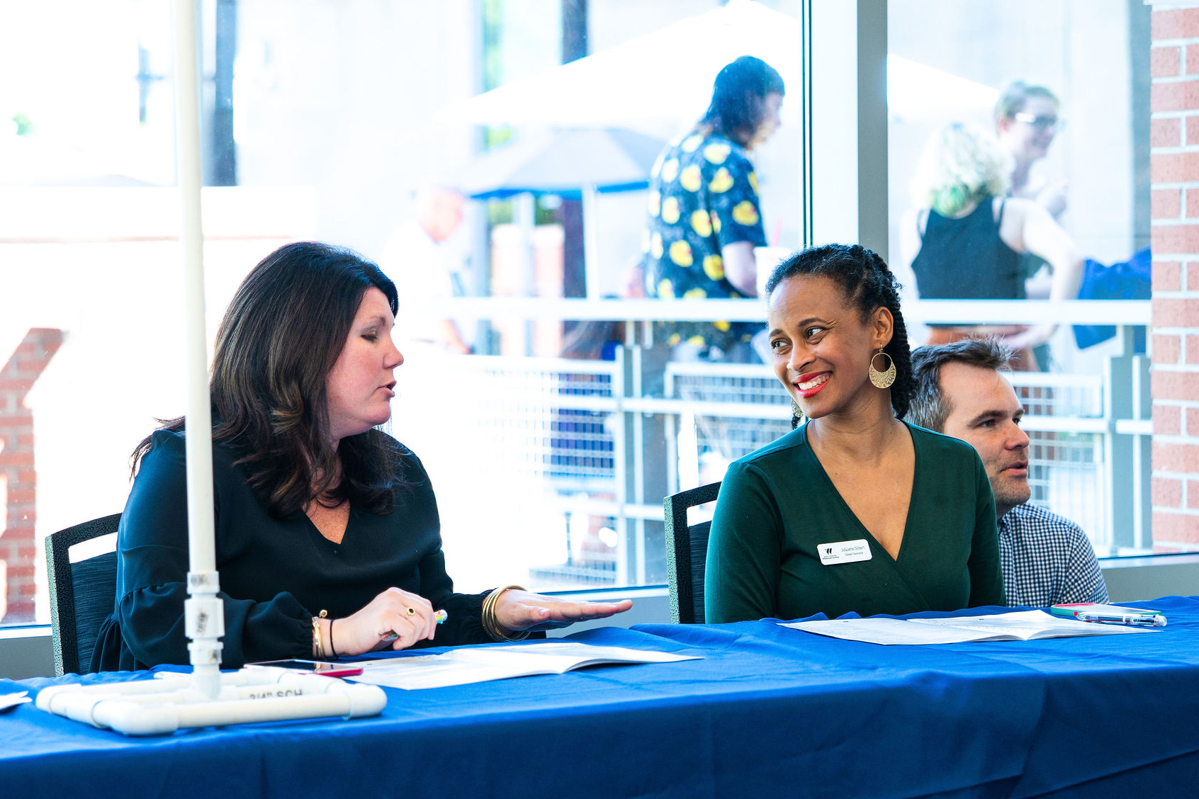 Faculty and staff speaking with each other