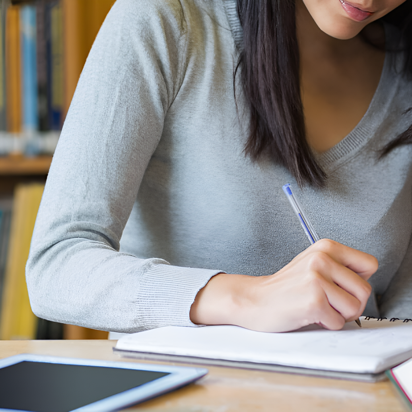 woman writing on her notebook