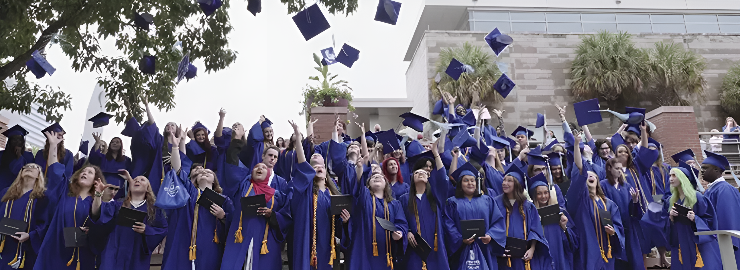 whitmore students throwing up the graduation cap