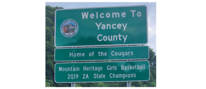 Sign saying Welcome to Yancey County - Home of the Cougars - Mountain Heritage Girls Basketball 2019 2A State Champions