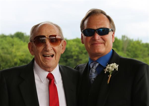 Two elderly guys wearing suit and tie and sunglasses.