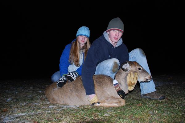 Students hugging a deer