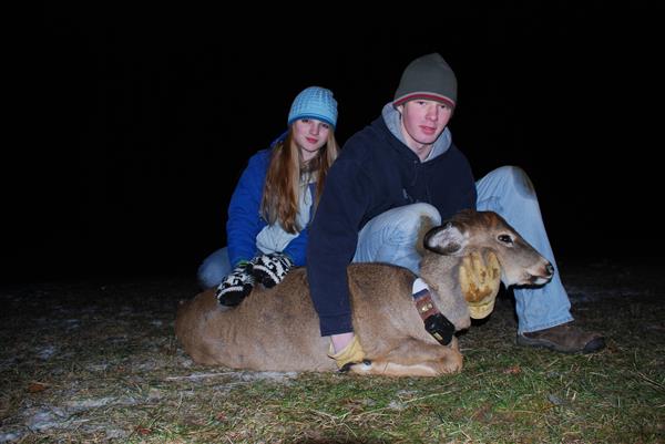 Students hugging a deer