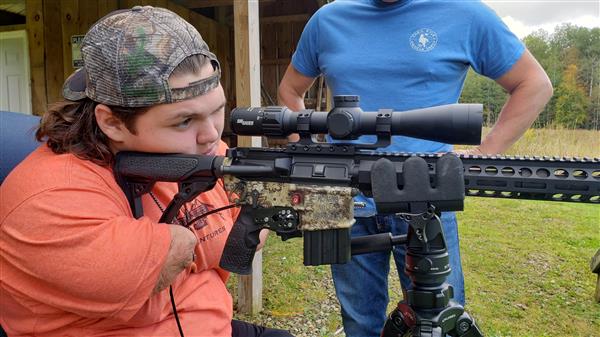 Memphis Lafferty and his father Chris Lafferty with their hunting gun.