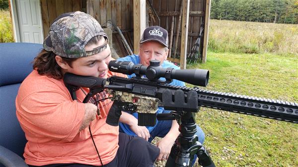 Memphis Lafferty and his father Chris Lafferty with their hunting gun.