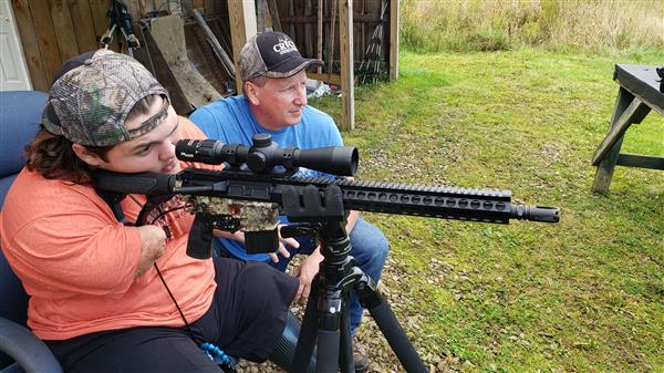 Memphis Lafferty and his father Chris Lafferty with their hunting gun.