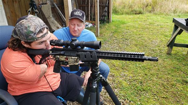 Memphis Lafferty and his father Chris Lafferty with their hunting gun.