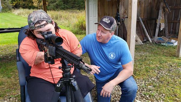 Memphis Lafferty and his father Chris Lafferty with their hunting gun.