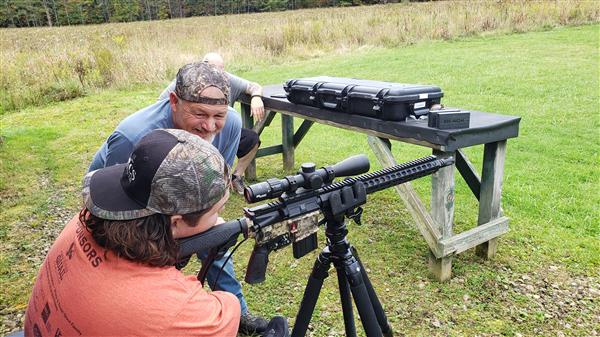 Memphis Lafferty and his father Chris Lafferty with their hunting gun.