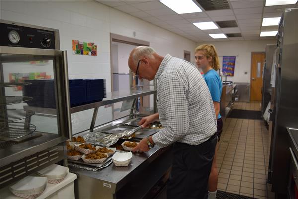 A man getting his meal on their pantry