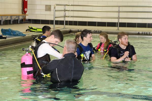 SCUBA Coach with his Students testing their equipment in the pool.