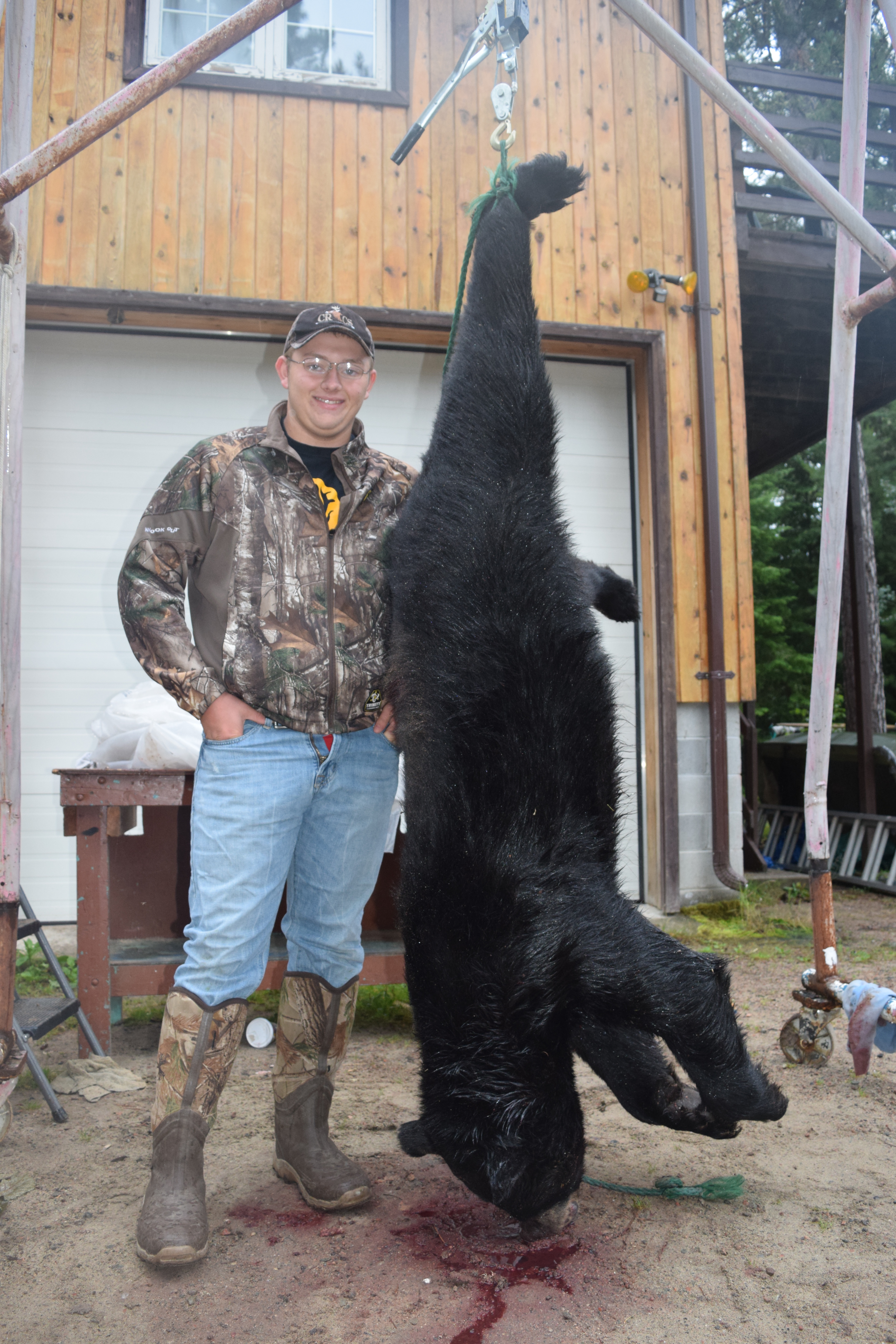 Student standing next to dead Black Bear.