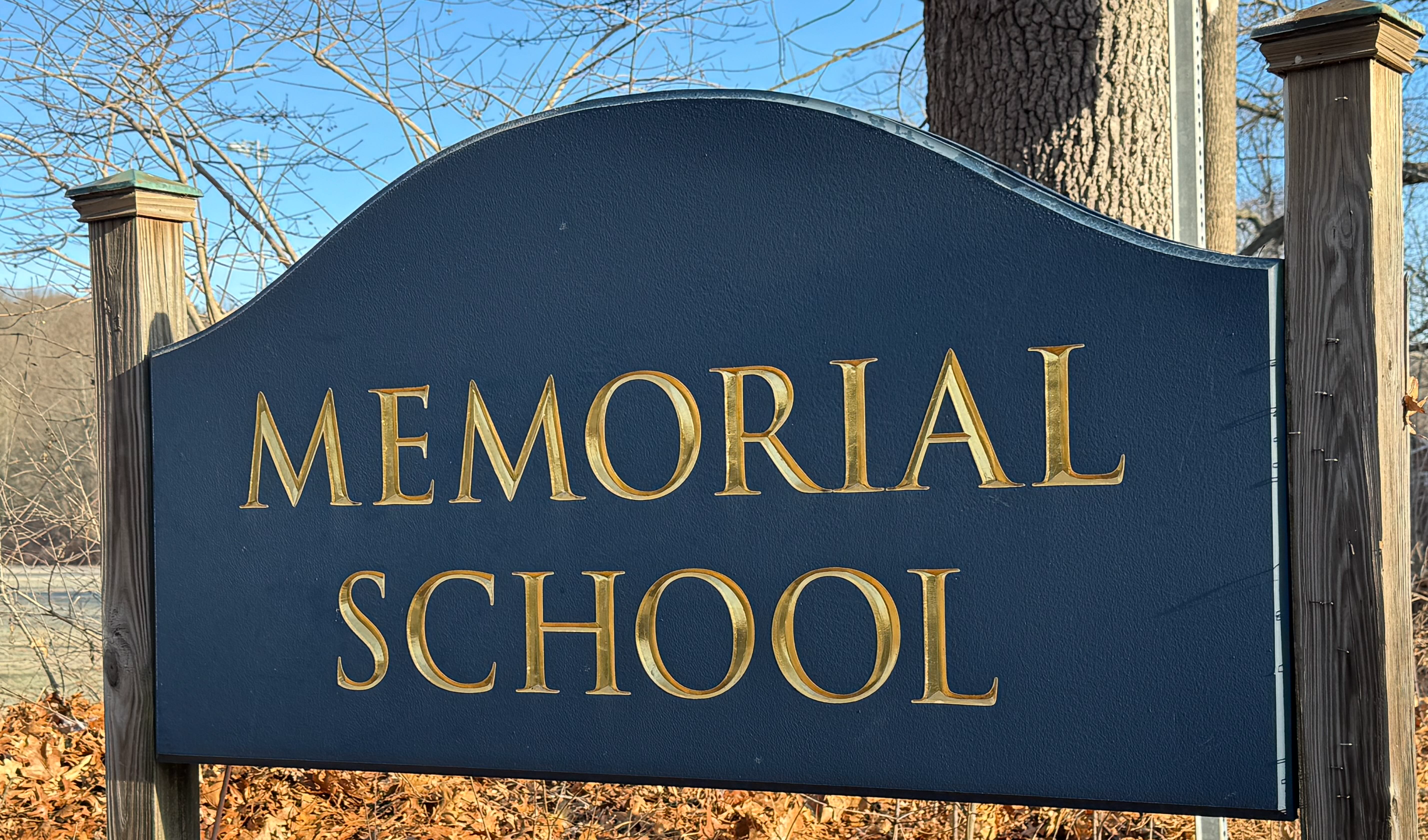 A crisp fall image of the entrance sign for Memorial School.