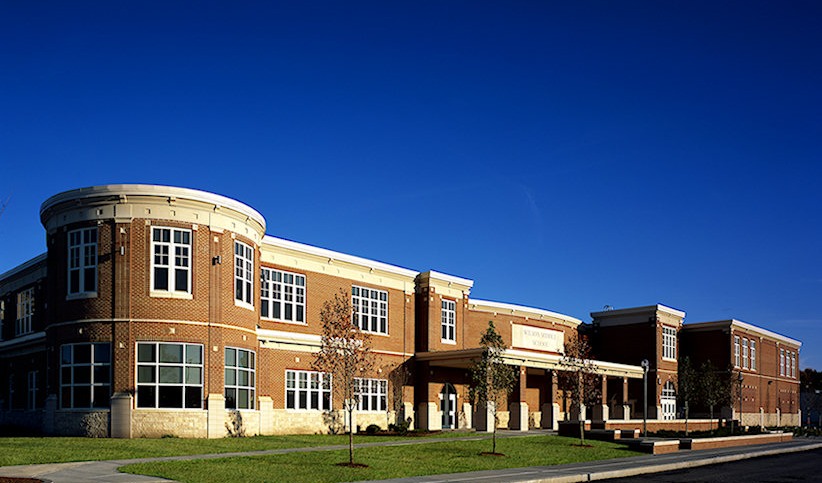 Wilson Middle School is pictured on a sunny day.  Building was built in 2003 and has a red-brick exterior