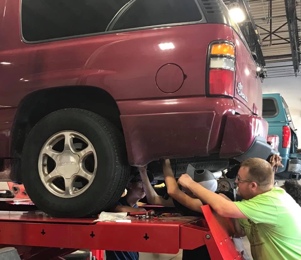 Students working under a car