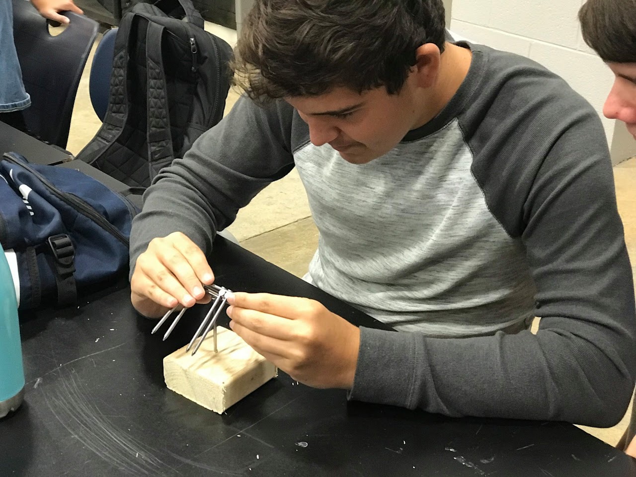 Structural engineering practice with small wood and metal figure