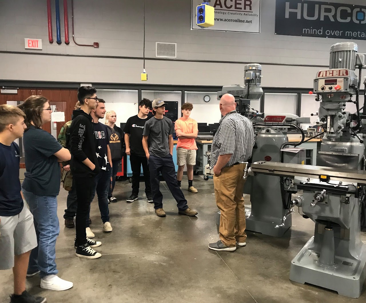 Class looking at very large machinery 