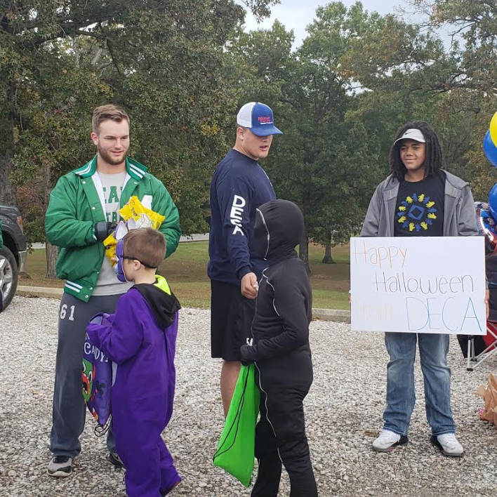Students giving out halloween candy