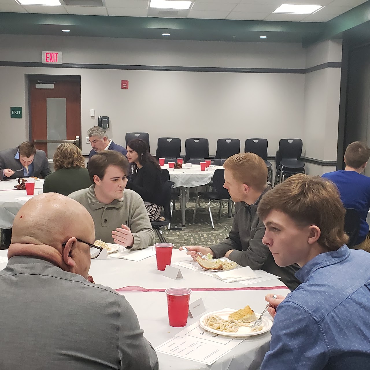 Students at a banquet with adults