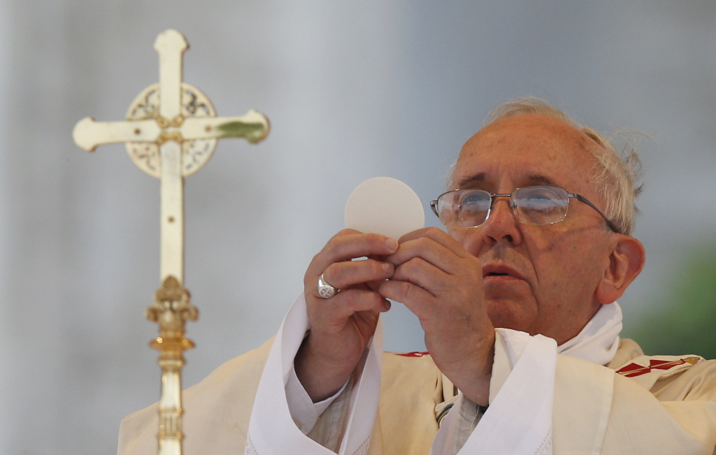 The Pope celebrates his inaugural mass at the Vatican, surrounded by clergy and worshippers.