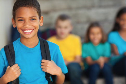 student with a backpack smiling