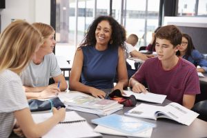 Teacher studying with students