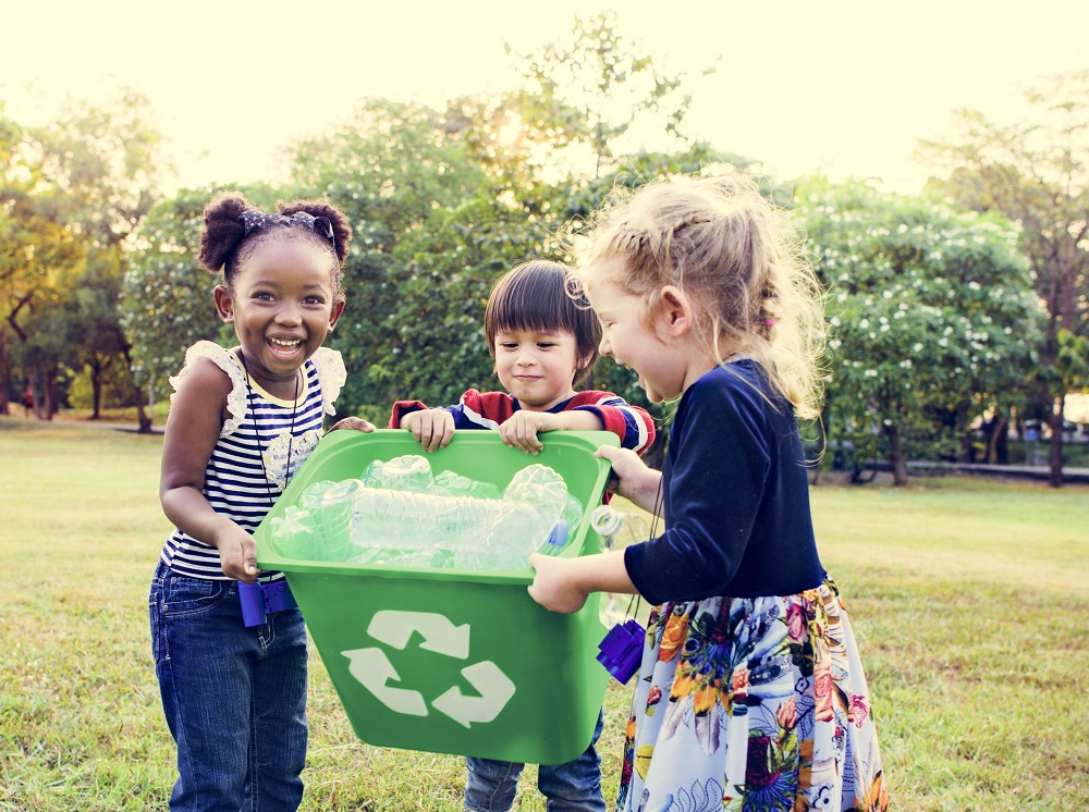 Elementary Students Putting Bottles in Bin