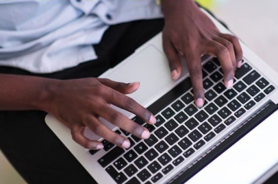 man typing on his computer