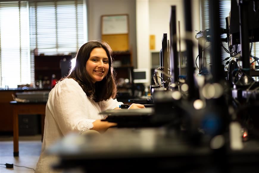 student happy using a computer for a school project