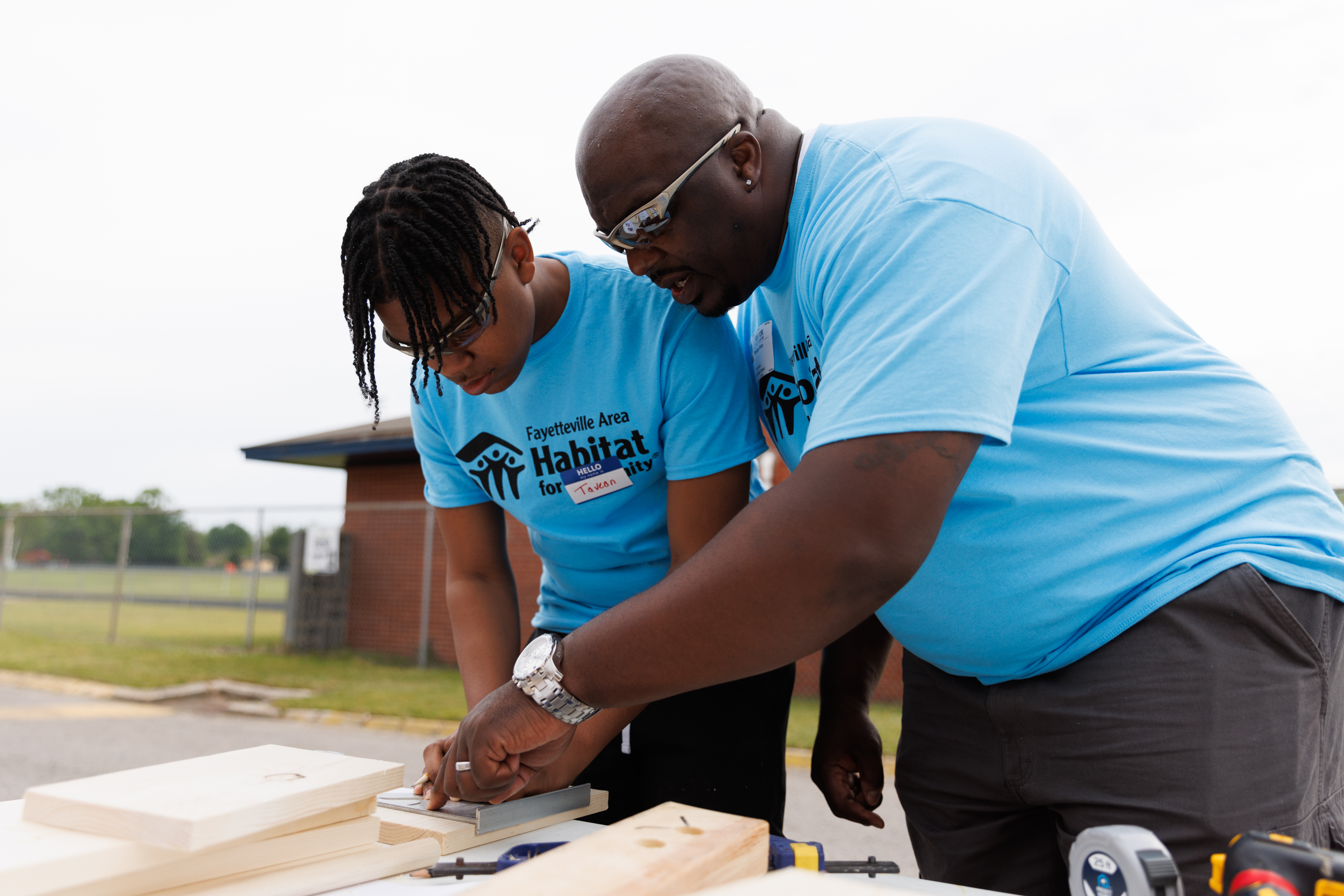 Mentor assisting a student with a hands-on building project.