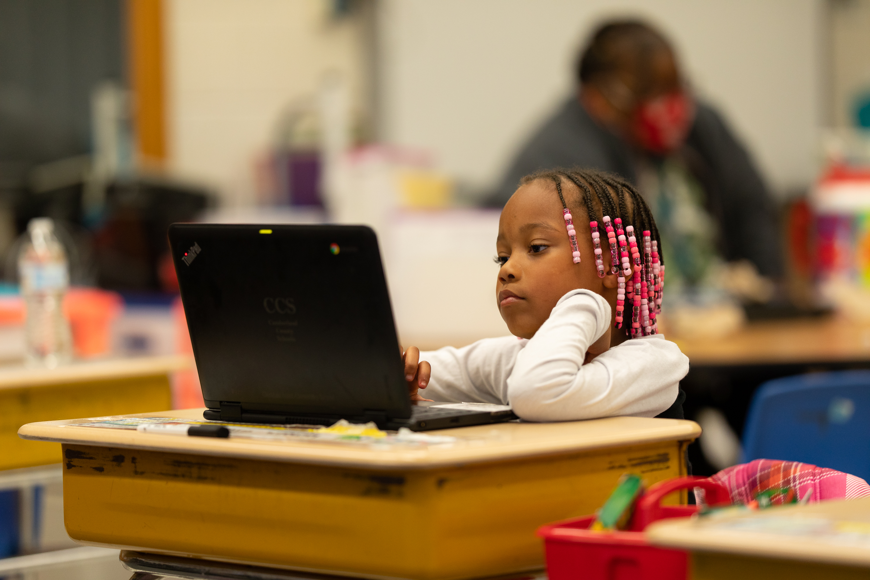 Student working at a desk on a computer.