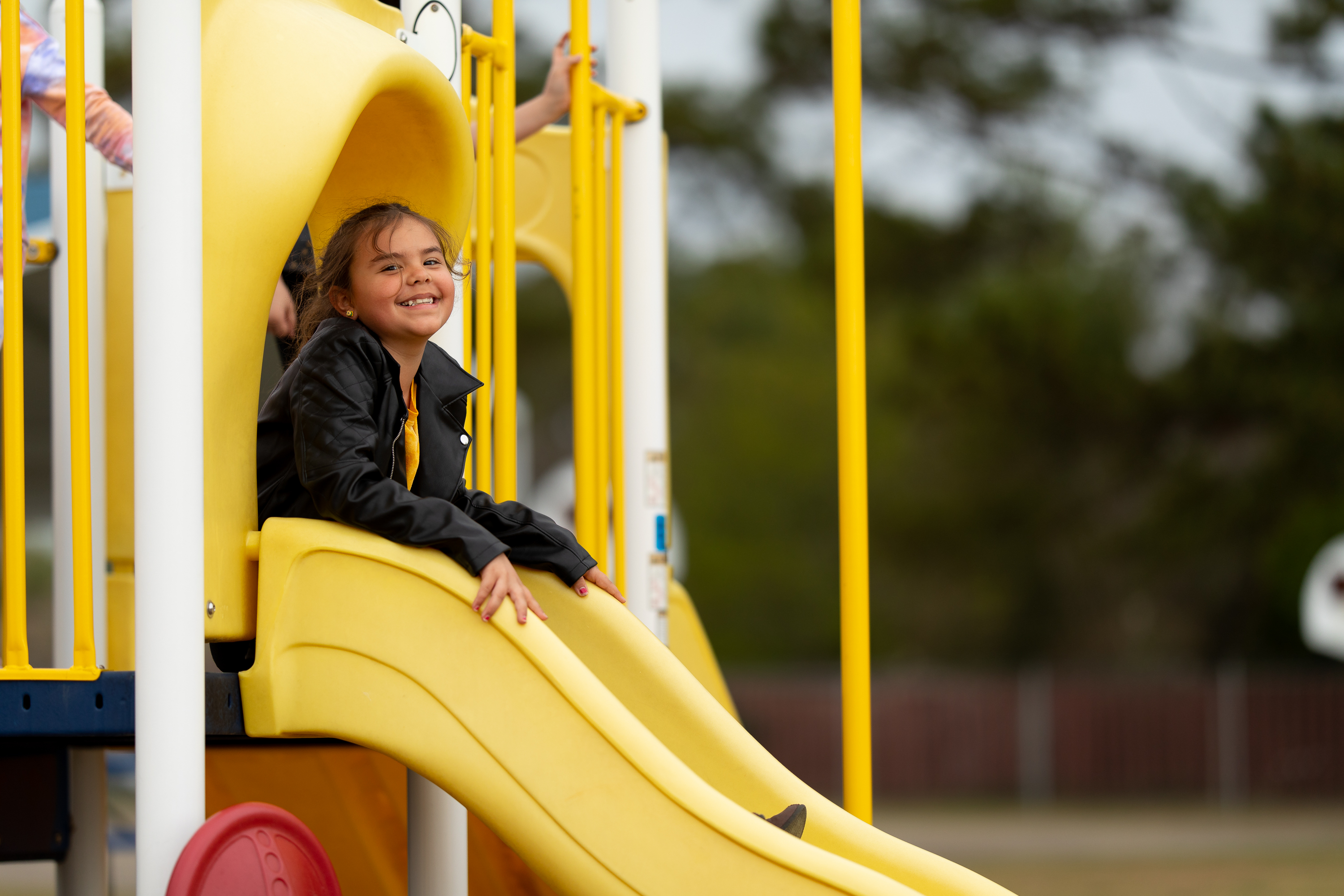 Student playing on a playground slide.