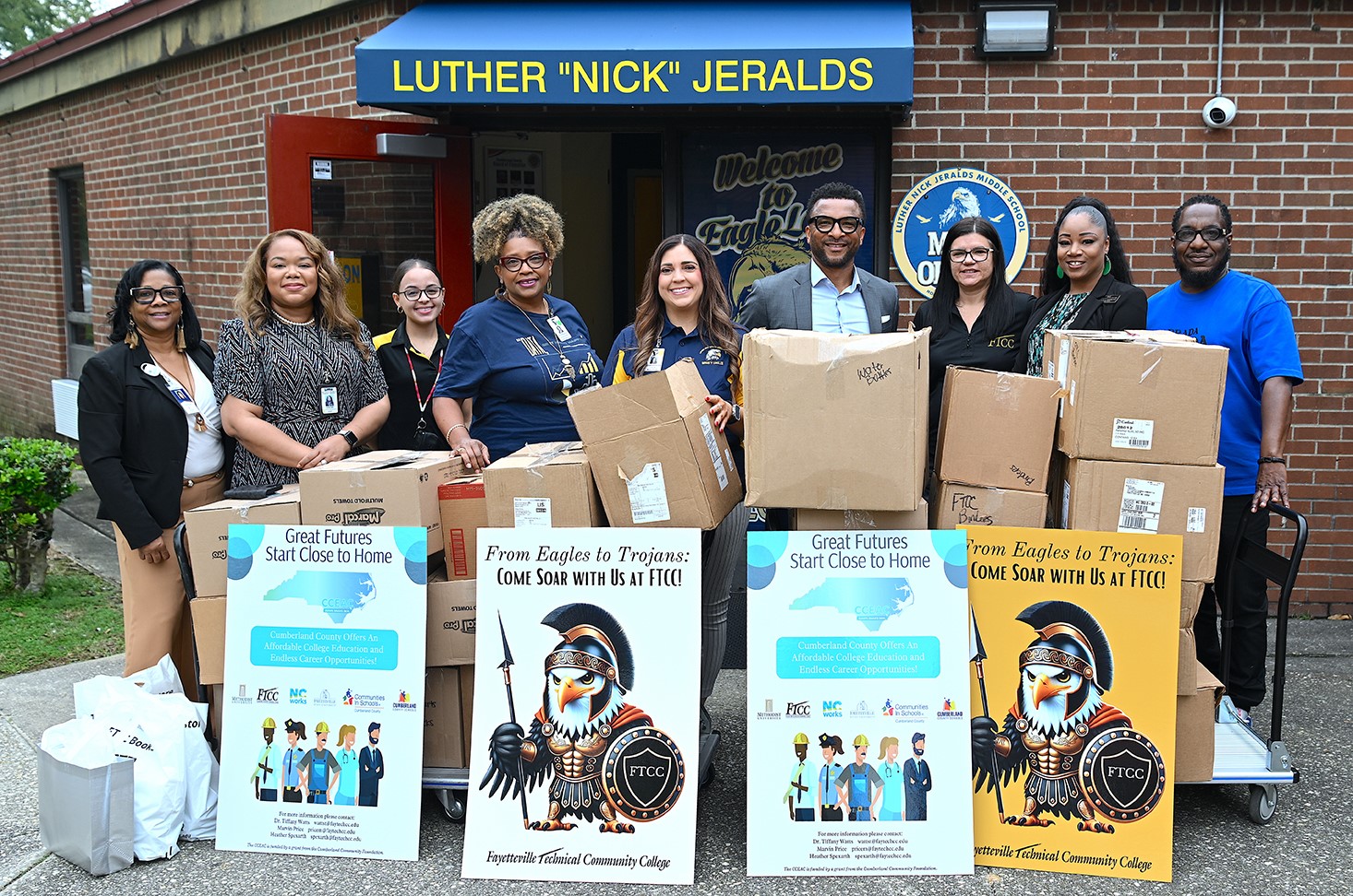 Group photo of Community Partners making a donation to a school.