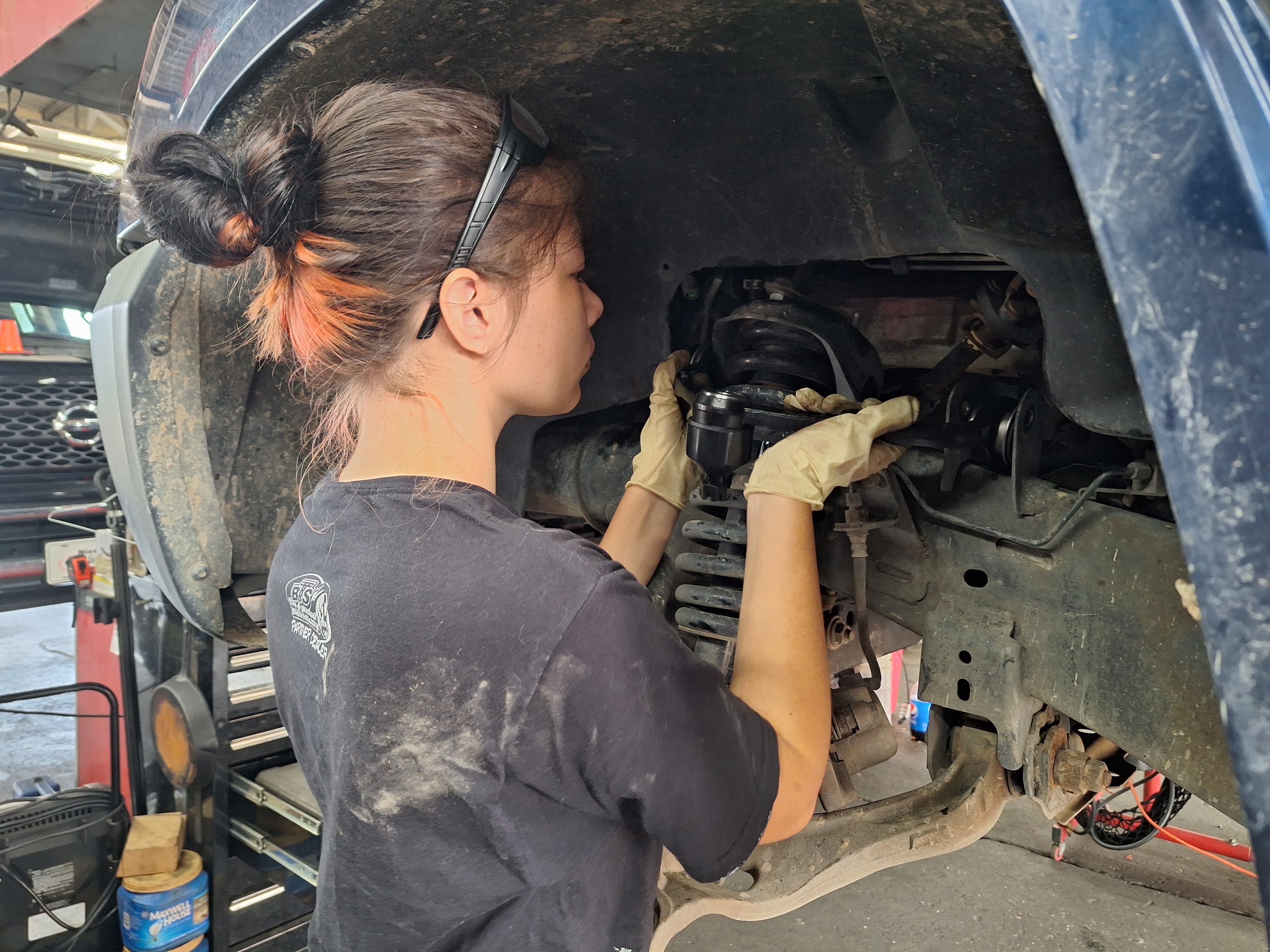 Career and Technical Education student working on a car